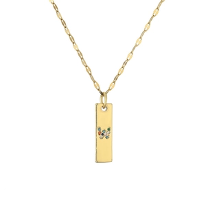Detail shot of golden rectangular pendant with letter W in colorful rhinestones