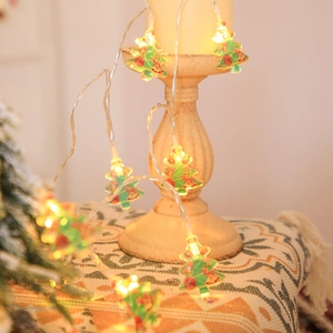 LED Christmas tree fairy lights wrapped on a vintage candle holder in a warm home setting