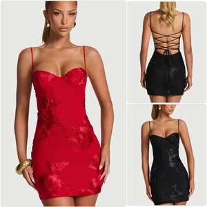 Detailed view of red 3D floral embroidery and lace-up back on fitted cocktail dress