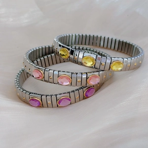 Three-piece stretch stainless steel bracelet set with colorful oval gemstones and gold rivets