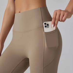 Detail view of high waist yoga leggings with functional side pockets for mobile phones