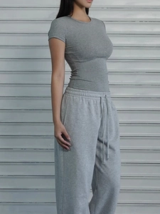 Detail of dark gray slim fit t-shirt with light gray drawstring athletic pants