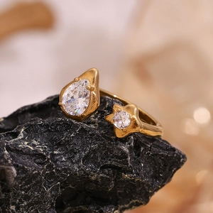 Macro shot of 18K gold plated open ring featuring water drop and star zircon details
