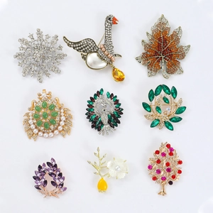 Collection of nine detailed enamel brooches with rhinestones in animal and floral motifs