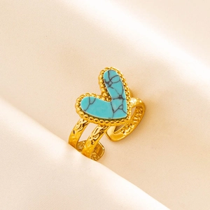 Macro shot of vintage gold adjustable ring with heart-shaped turquoise and ornate engravings