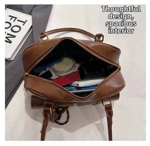Top view of brown vintage leather bag interior showing high storage capacity and zipper