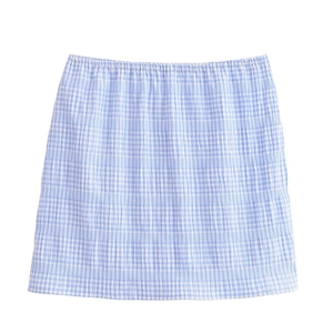 Detailed view of blue and white plaid skirt with textured fabric and elastic waist
