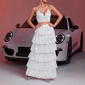 Detailed close-up of white sequin two-piece set featuring layered tiered maxi skirt texture