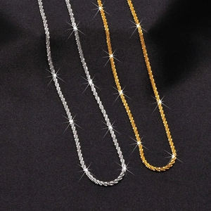 Minimalist gold and silver sparkling titanium steel necklace displayed on a black background