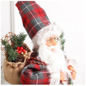 Detail of Santa figurine featuring a red plaid outfit and burlap bag with pine cones
