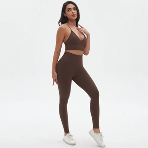 Detail of high-waisted seamless yoga pants and deep V-neck sports bra in dark brown
