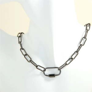 Macro shot of gun black metal chain necklace with oval carabiner pendant on a mannequin