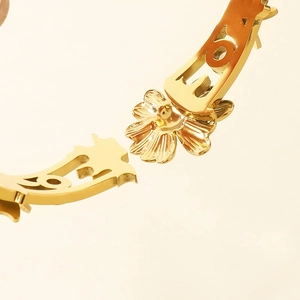 Gros plan macro détaillé sur la gravure florale dorée et l'artisanat ajouré du bracelet