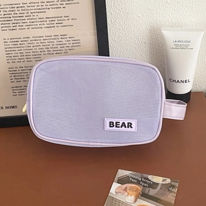 Detail of light purple mesh cosmetic bag with Bear label and zipper closure