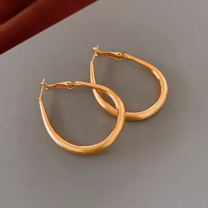 Minimalist gold plated teardrop hoop earrings with smooth matte finish and secure closure