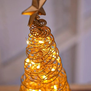 Detail of golden spiral iron Christmas tree lamp with LED lights and star topper