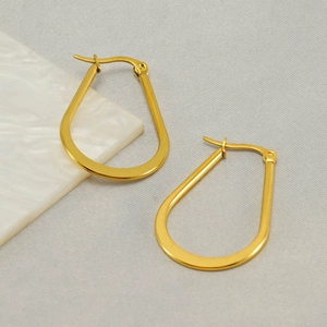 U-shaped stainless steel earrings in gold finish displayed on marble background