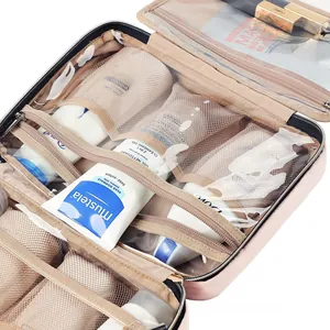 Close-up of pink travel toiletry bag interior with mesh pockets and elastic organizers