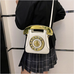 Creative ivory white telephone shaped crossbody bag shown from a back perspective view