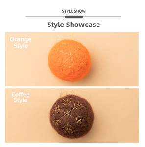 Detail of plush orange and brown Christmas balls with golden snowflake embroidery