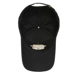 Internal view of black cotton baseball cap showing six-panel structure and metal buckle