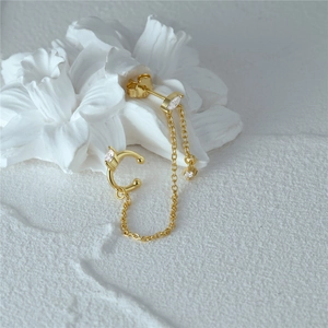 Macro view of gold S925 sterling silver chain earrings with opal and zircon details