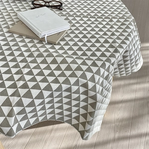 Detailed view of gray and white triangular geometric pattern on cotton linen round tablecloth