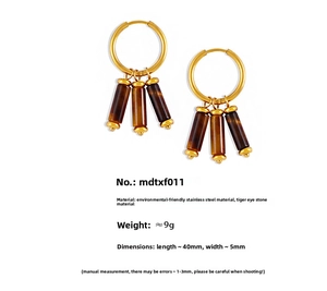Detailed view of gold stainless steel hoop earrings with tiger eye stone pendants