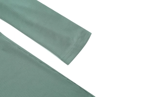 Detail shot of the double-needle stitching on the sage green ribbed knit sleeve cuffs