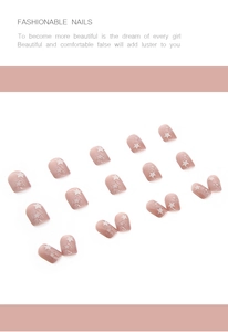 Close-up of glossy pink press-on nails featuring white star patterns in various sizes
