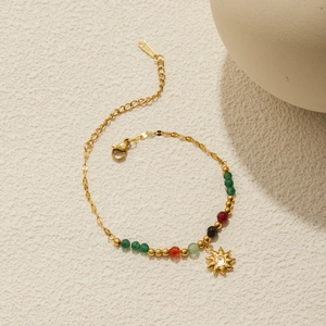 Detail of 18K gold stainless steel chain bracelet with colorful beads and sun pendant