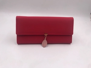 Detail view of watermelon red PU leather long wallet with leaf pendant and gold hardware