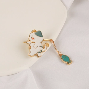 Creative cat fishing brooch with blue hat and hanging fish charm on white fabric