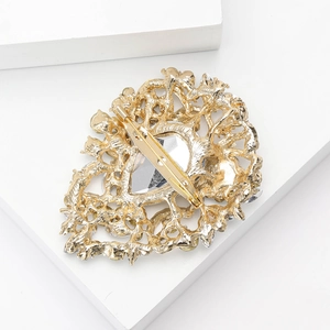 Detailed back view of a vintage alloy brooch showing sturdy metal pin and filigree craft