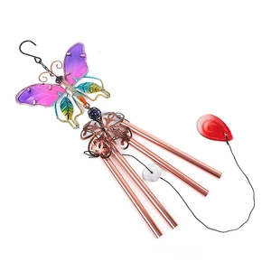 Detail of colorful glass butterfly ornament with four rose gold metal wind chime tubes