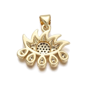 Macro detail of gold-plated evil eye pendant with embedded dark zircon for jewelry making