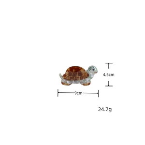 Detail view of tortoise hair claw clip showing dimensions 9cm by 4.5cm and 24.7g weight