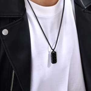 Men's stainless steel necklace with geometric black tire pattern pendant on a curb chain