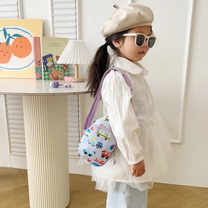 Detail of cute blue kids cartoon car crossbody bag with adjustable purple strap