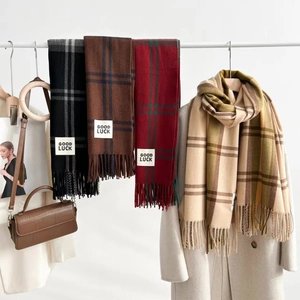 Classic oversized plaid cashmere-feel scarf with tassels in neutral tones hanging elegantly