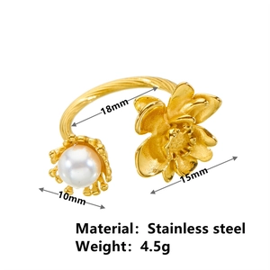 Gold stainless steel open ring with pearl and rose flower charm details on white background