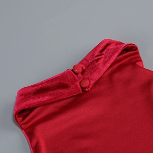 Macro shot of red velvet dress collar featuring two matching fabric-covered buttons