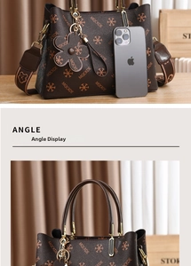 Detail view of brown tote bag with vintage monogram print and metal handle design