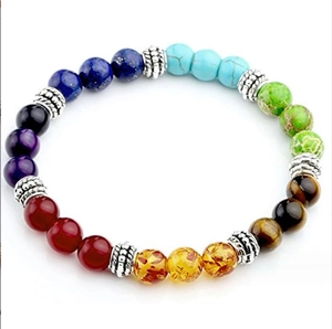 Detail of 8mm seven chakra natural stones and lava beads on a leather wrap bracelet