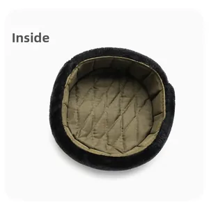 Detailed interior view of winter trapper hat featuring quilted lining and faux fur trim