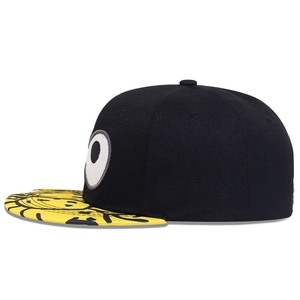 Minion-style embroidery snapback hat with black crown and yellow graffiti patterned brim