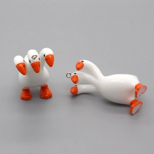 Creative three-headed goose pendant in white with orange beaks and metal ring