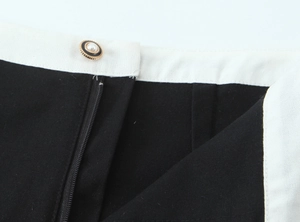 Macro detail of high-quality zipper and decorative pearl buttons on contrast vest dress set