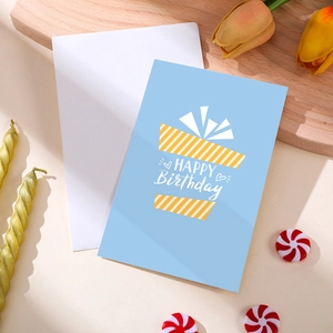 Blue birthday card with yellow gift box pattern and white Happy Birthday script
