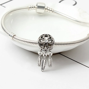 Silver dreamcatcher charm with three feather pendants on a classic snake chain bracelet